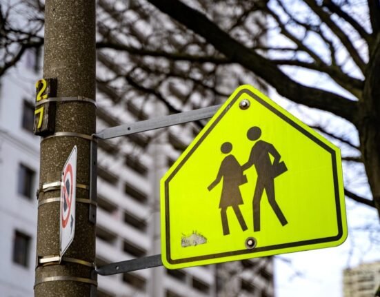 Why do school zone signs use that distinctive loud, bright, fluorescent yellow-green color